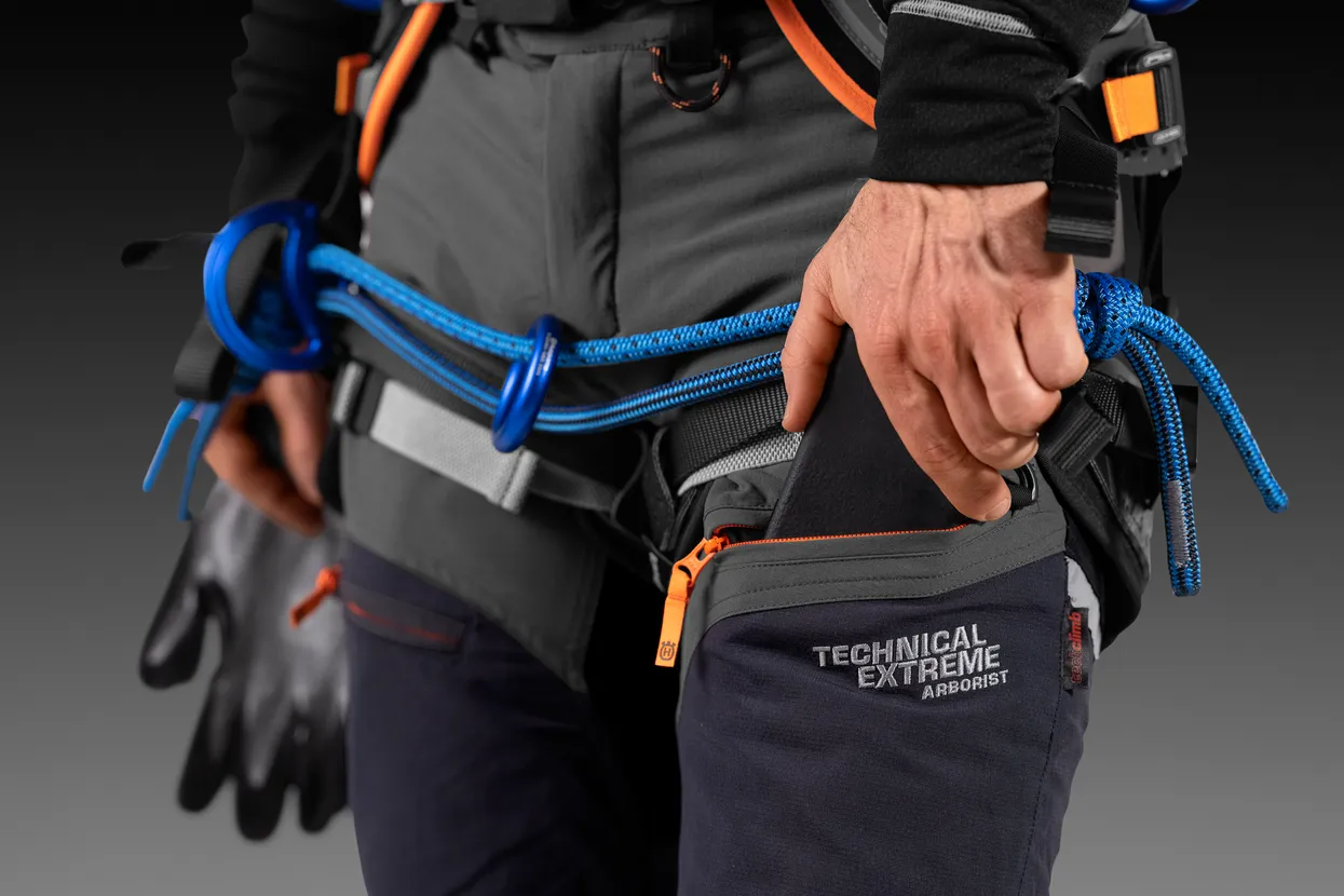 Optimised design for tree climbers includes pre-bent knees, reversed zipper pockets, and loops for carabiners